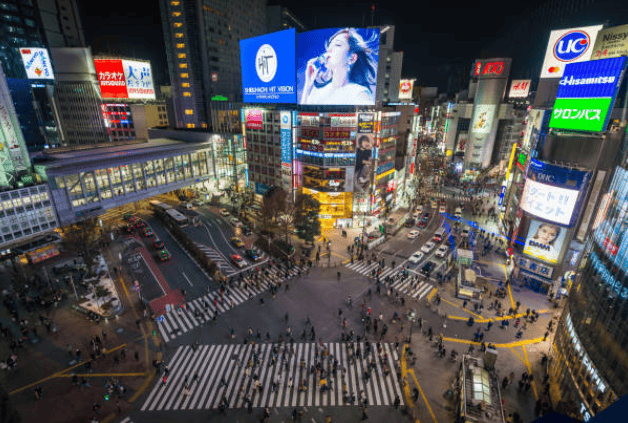 Bright cityscape of Times Square, illuminated billboards, vibrant lights, busy crossings, night view in New York City.